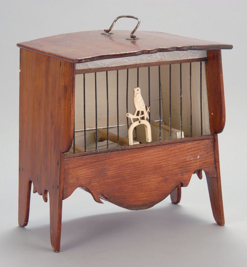 Appraisal: WOODEN BIRDCAGE American th CenturyIn pine with ivory bird mounted