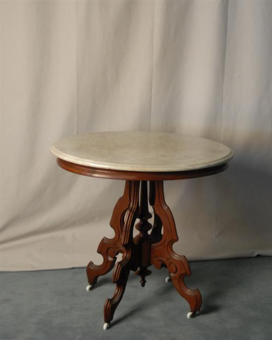 Appraisal: A Victorian Walnut Marble-top Occasional Table having an oval white