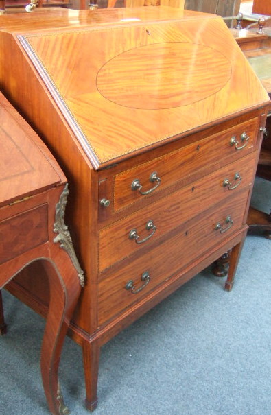 Appraisal: An Edwardian satin wood bureau the fall enclosing a fitted