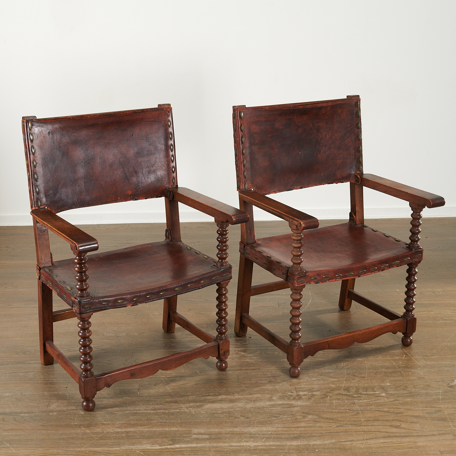 Appraisal: PAIR SPANISH BAROQUE STYLE ARMCHAIRS Likely th c carved walnut