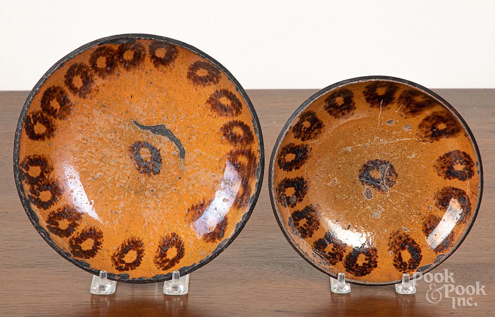 Appraisal: Two Pennsylvania redware plates Two Pennsylvania redware plates with manganese