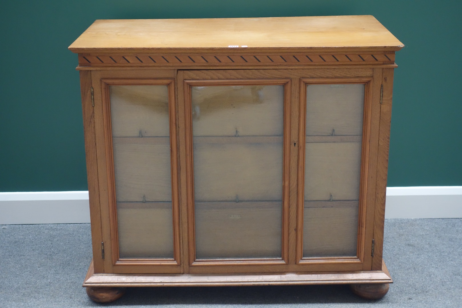 Appraisal: A th century oak free standing collector's cabinet each side