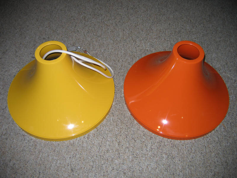 Appraisal: PAIR PLASTIC HANGING LIGHT FIXTURES of cone-form yellow and orange