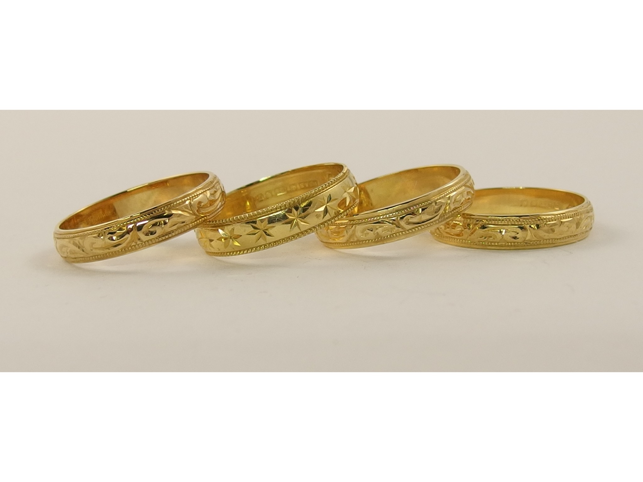 Appraisal: Four ct ladies wedding rings all with hand engraved patterns