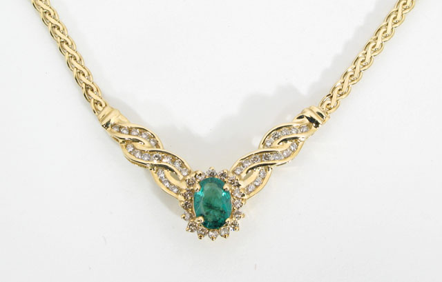 Appraisal: EMERALD DIAMOND AND FOURTEEN KARAT GOLD NECKLACE the V-shaped pendant