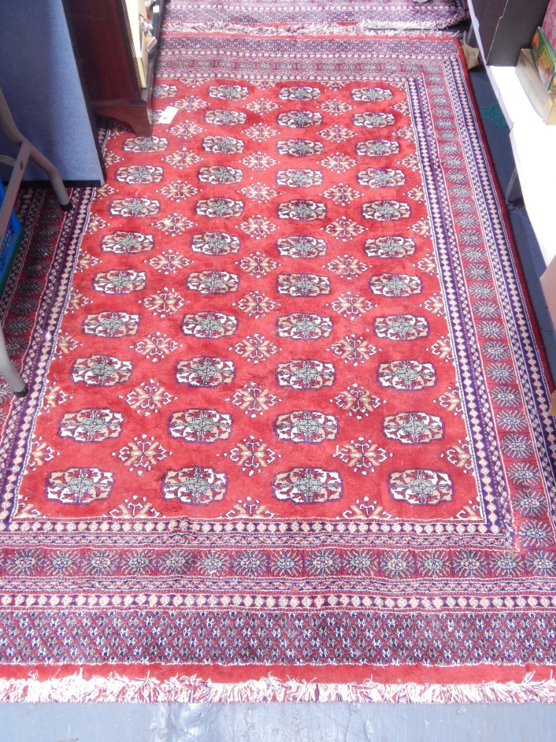 Appraisal: A Shiraz red ground rug decorated with floral medallions cm