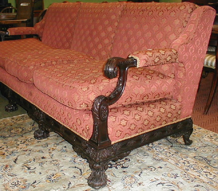 Appraisal: An early thC upholstered walnut framed three seater sofa with