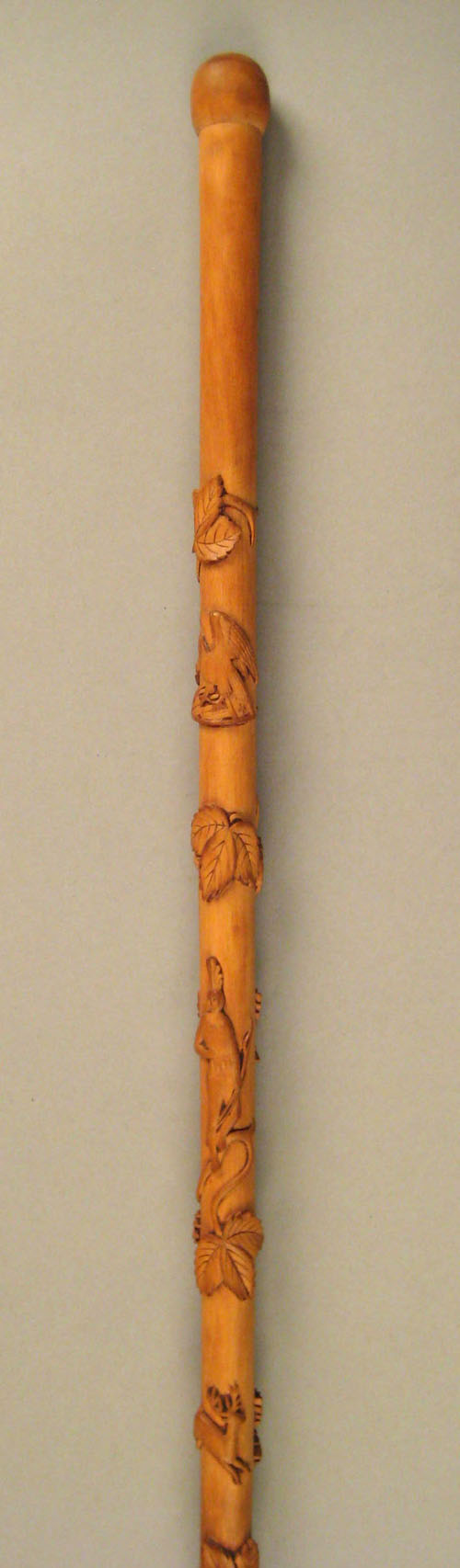 Appraisal: Carved cane with relief trailing vines deer Indian and eagle