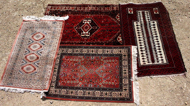 Appraisal: FOUR TH CENTURY CARPET RUGS two on red ground one