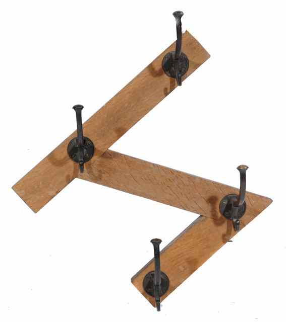 Appraisal: A SET OF FOUR BRONZE COAT HOOKS on an oak