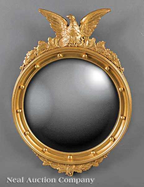 Appraisal: An Antique Carved Giltwood Bullseye Mirror th c surmounted with