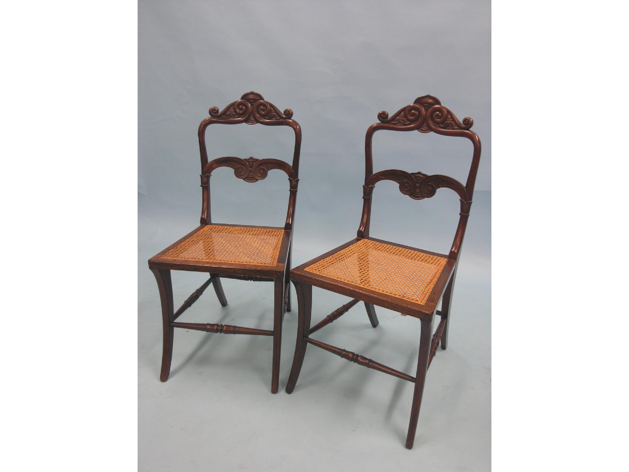 Appraisal: A pair of Colonial rosewood single chairs carved scroll backs