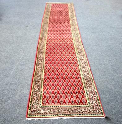 Appraisal: An Araak runner with repeating motif to a tomato red