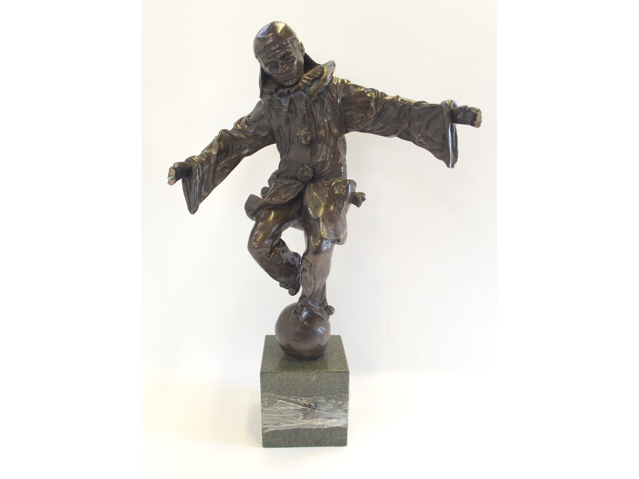 Appraisal: Bronzed resin figure of a Pierrot balancing on a ball