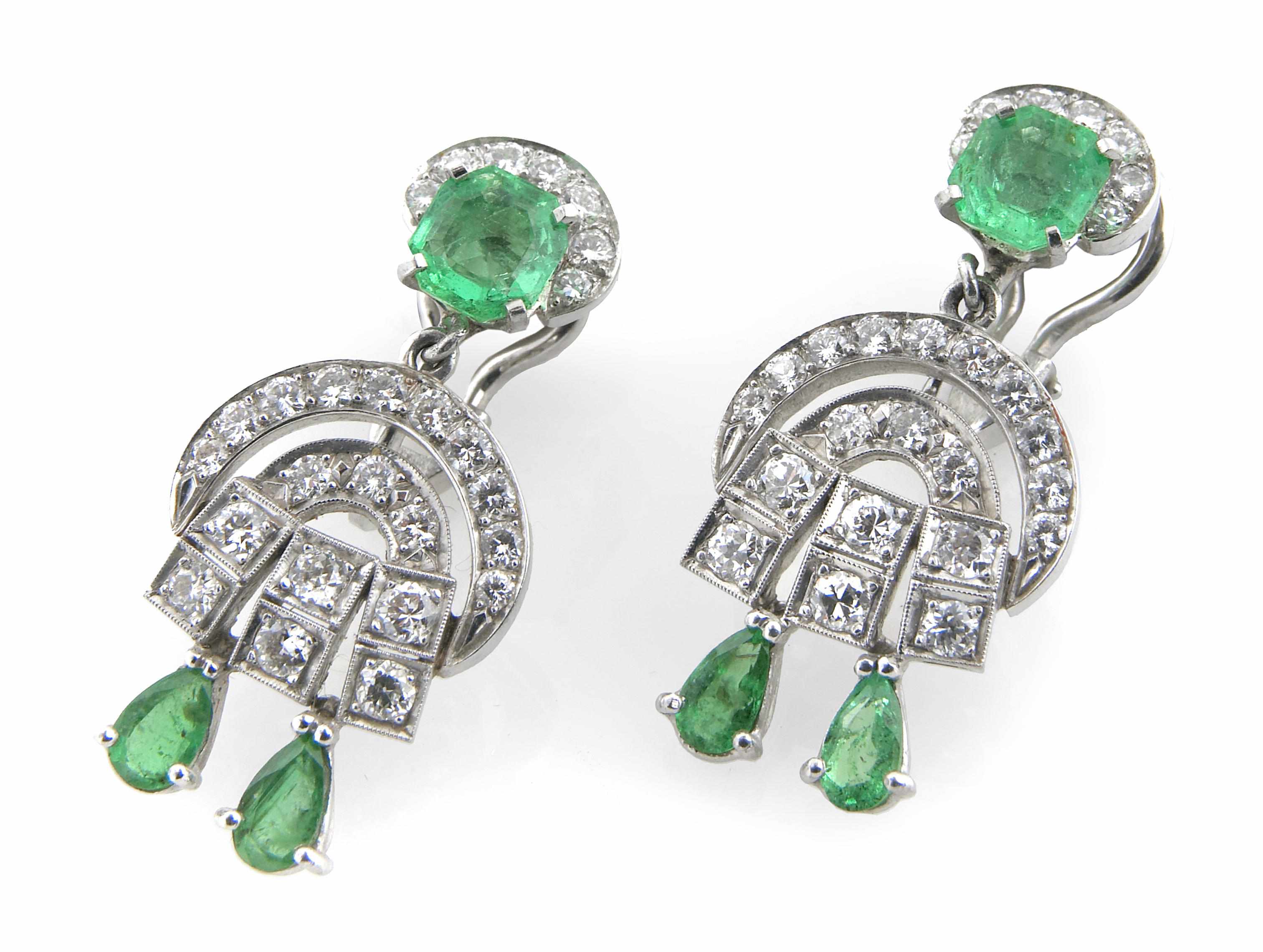 Appraisal: A pair of diamond emerald and white gold earclips length