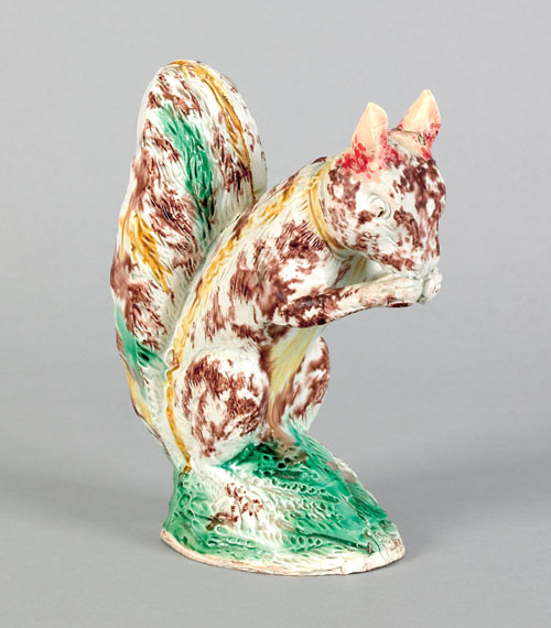 Appraisal: Ralph Wood Staffordshire figure of a seated squirrel eating a