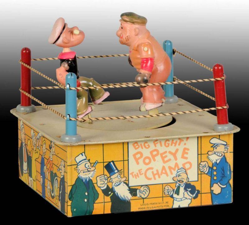 Appraisal: Tin Celluloid Marx Popeye the Champ Wind-Up O B Description