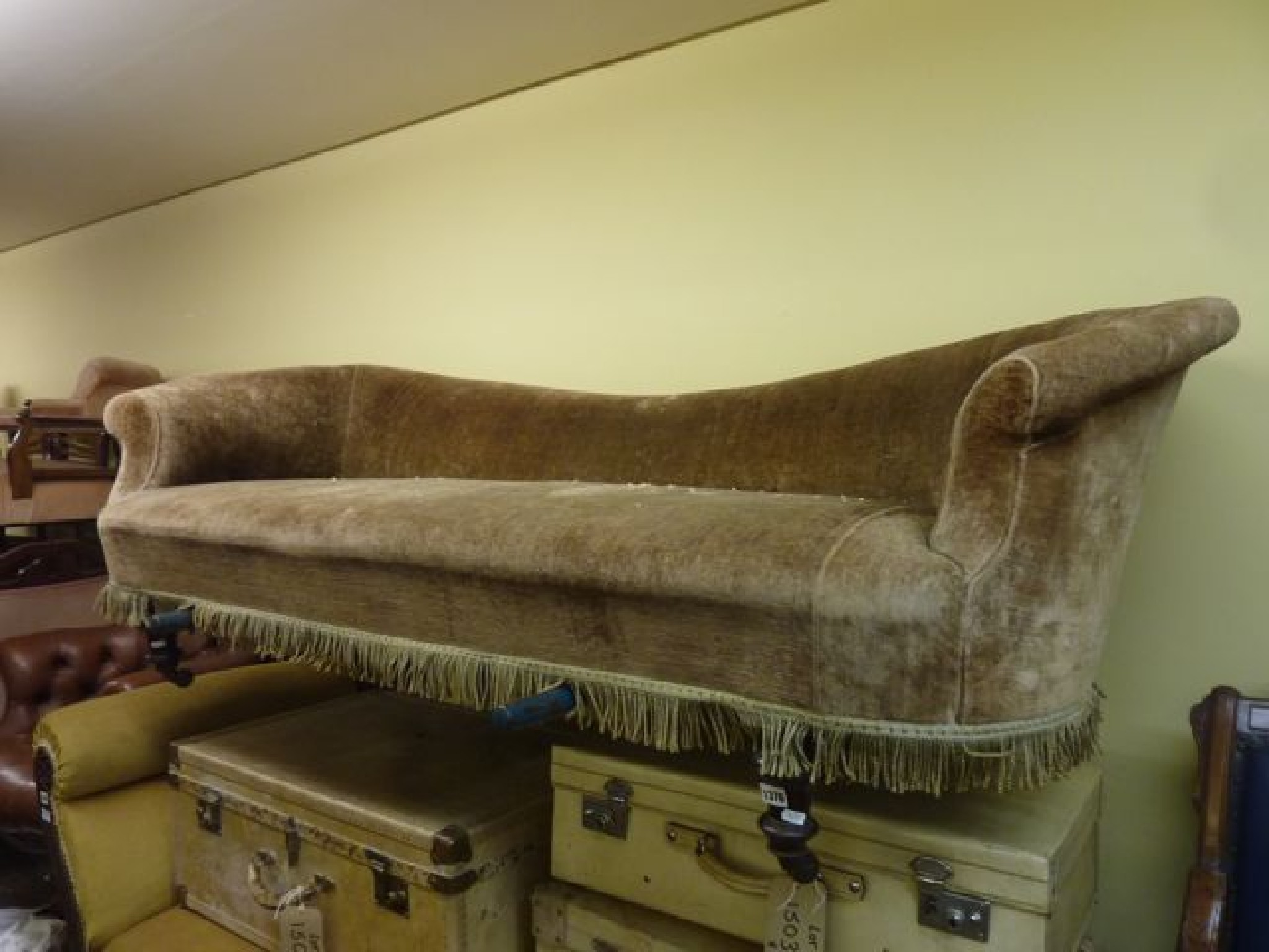 Appraisal: A Victorian sofa with shaped outline and scrolled arms raised