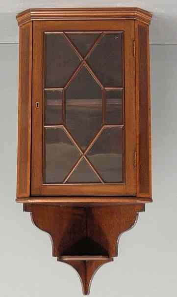 Appraisal: Diminutive inlaid mahogany hanging cupboard with crosshatched mullioned glass door