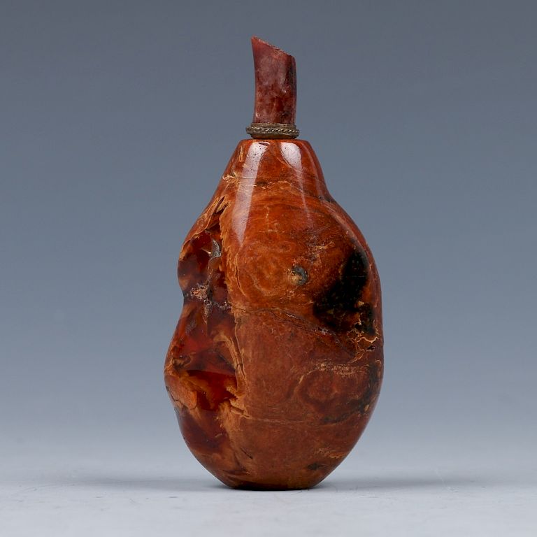 Appraisal: AMBER PEBBLE FORM SNUFF BOTTLE QING Of a pebble from