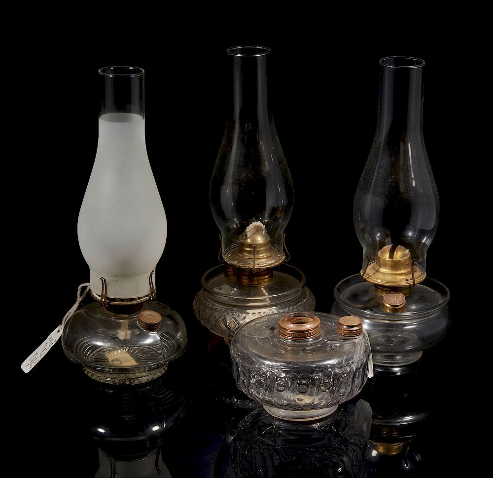 Appraisal: Four Clear Glass Oil Lamps Four assorted clear glass oil