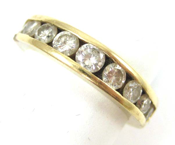 Appraisal: DIAMOND AND FOURTEEN KARAT GOLD RING with nine round-cut graduating