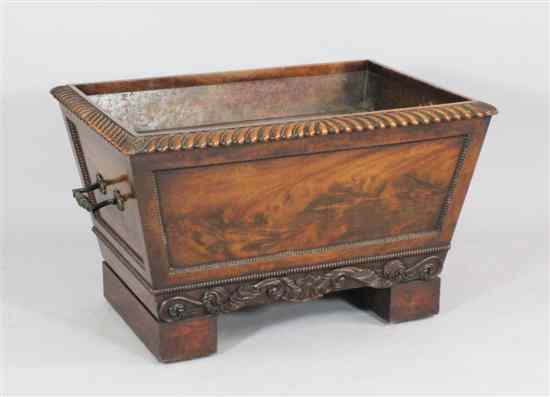 Appraisal: A William IV carved mahogany sarcophagus shaped cellaret with gadrooned