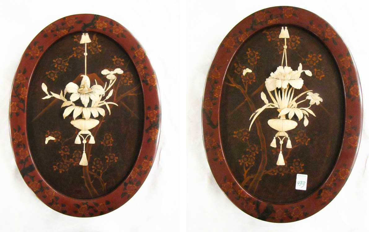 Appraisal: A PAIR OF CARVED BONE AND LACQUERED WOOD WALL PLAQUES