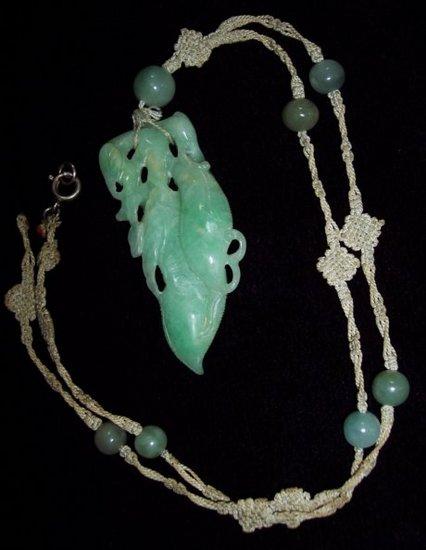 Appraisal: A jade pendant modelled as a branch in leaf on