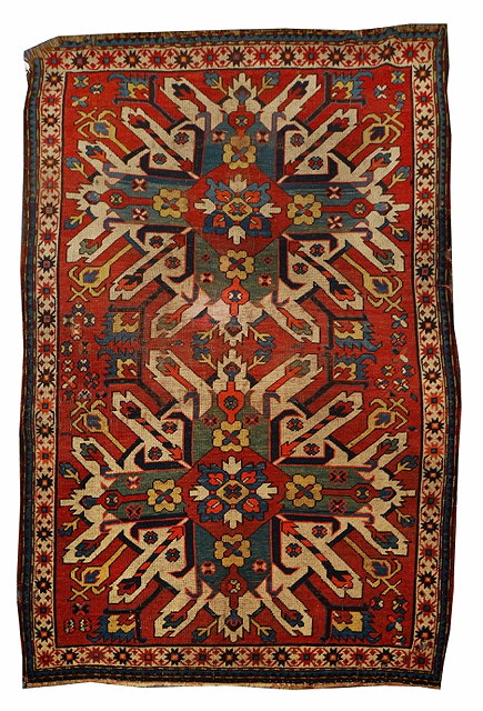 Appraisal: AN OLD KASAK RUST GROUND RUG with star medallions x