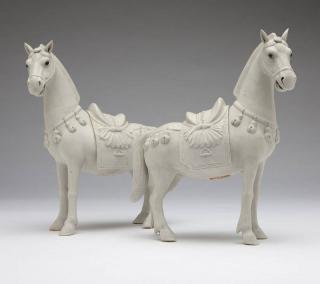 Appraisal: A pair of male and female Chinese bisque horses th