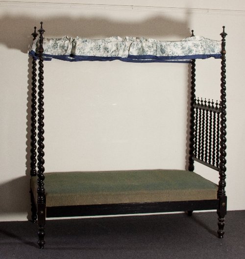 Appraisal: A pair of th Century ebonised four-poster single beds with