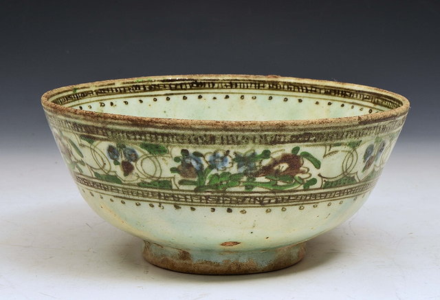 Appraisal: A PERSIAN POLYCHROME BOWL the exterior with simple band of