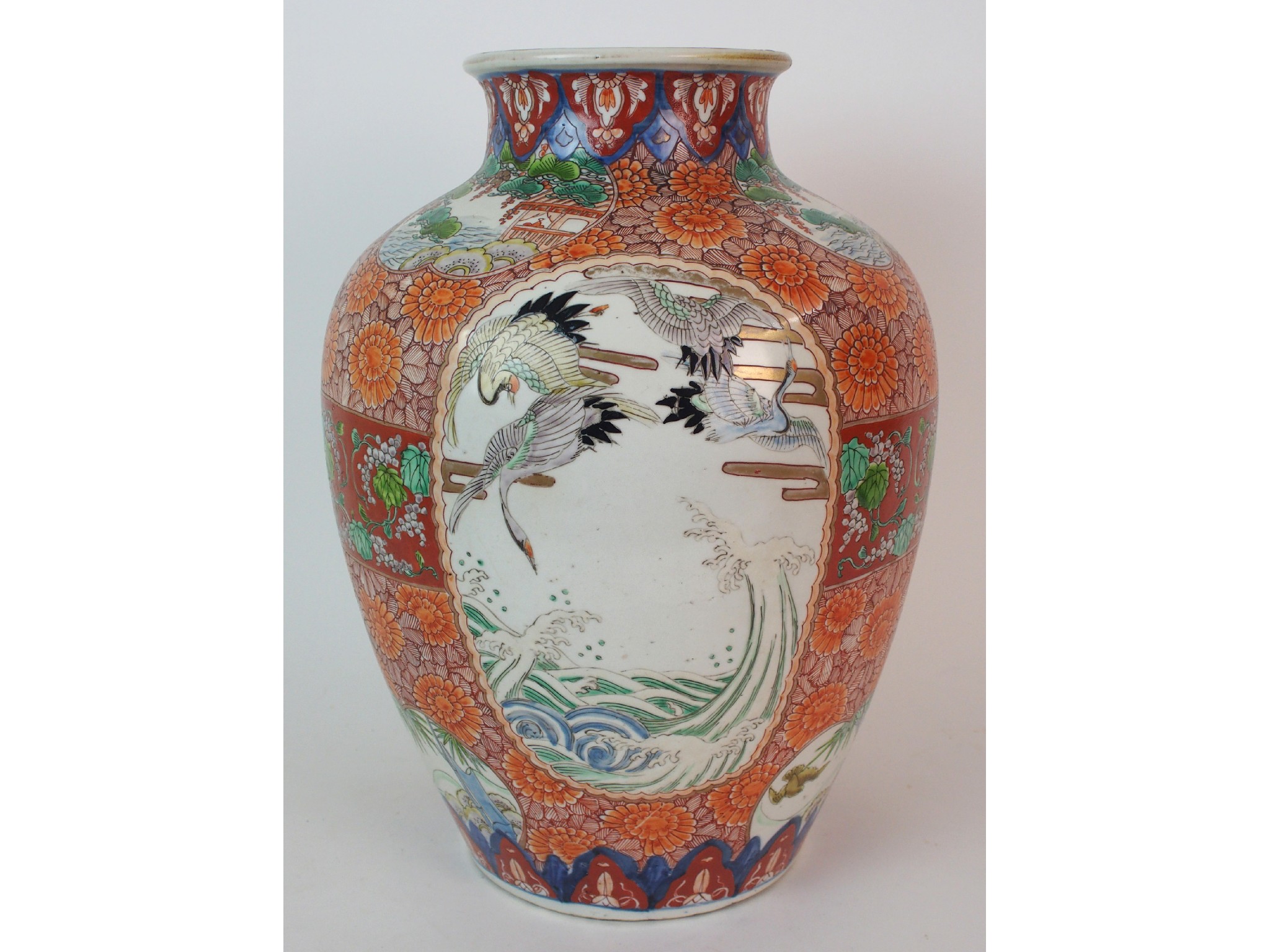 Appraisal: An Imari baluster vasepainted with panels of cranes above stormy