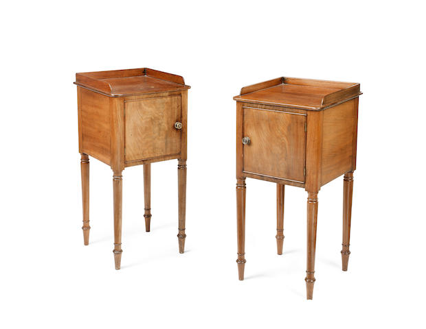 Appraisal: A pair of Regency mahogany bedside cupboards each with three