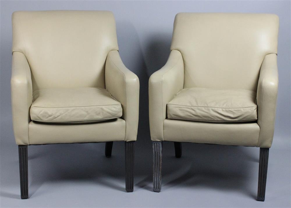 Appraisal: PAIR OF ROLL BACK BEIGE LEATHER ARMCHAIRS with rolled crest