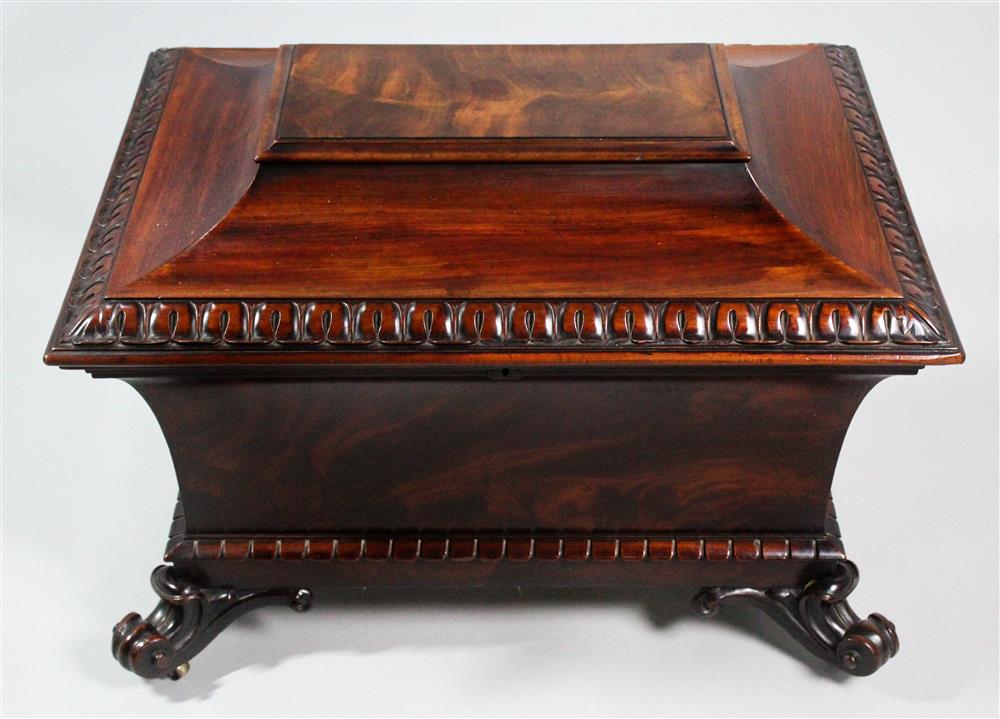 Appraisal: REGENCY CARVED MAHOGANY SARCOPHAGUS FORM CELLARETTE CIRCA the cellarette with