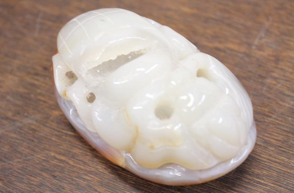 Appraisal: CHINESE CARVED ONYX NETSUKE FEATURING A SEA MONSTER LONG