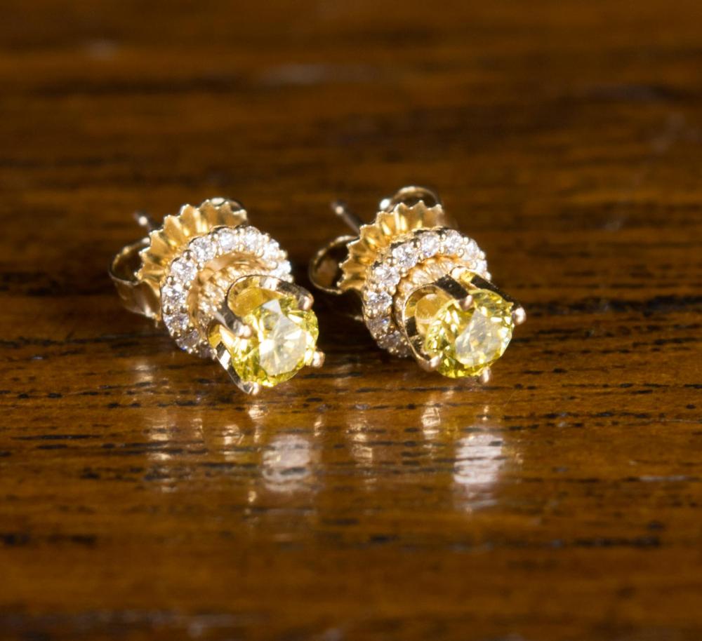 Appraisal: A PAIR OF YELLOW DIAMOND WHITE DIAMONDS AND FOURTEEN KARAT