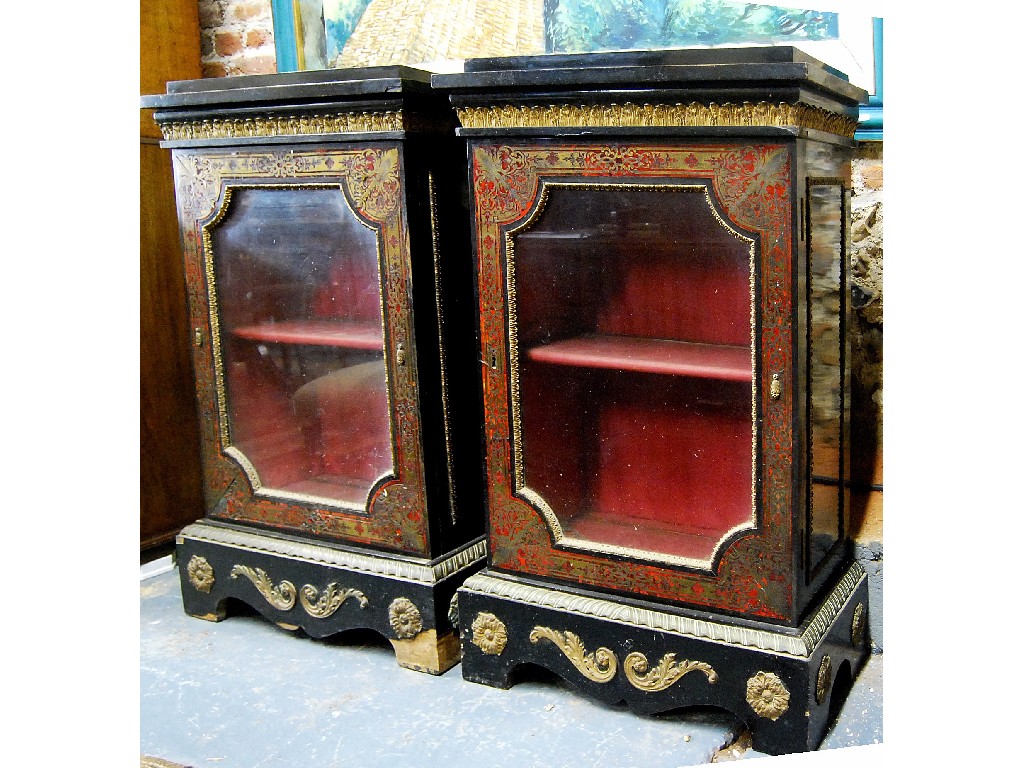 Appraisal: A pair of boule and ebony pier cabinets having shaped