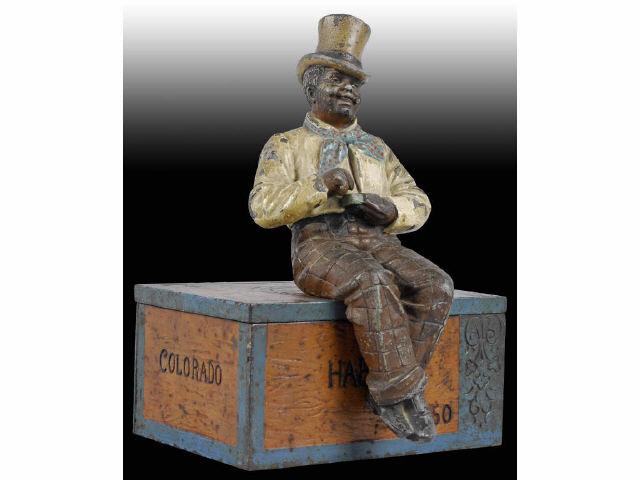 Appraisal: Cast Iron Black Man on Cigar Box Description Seven piece