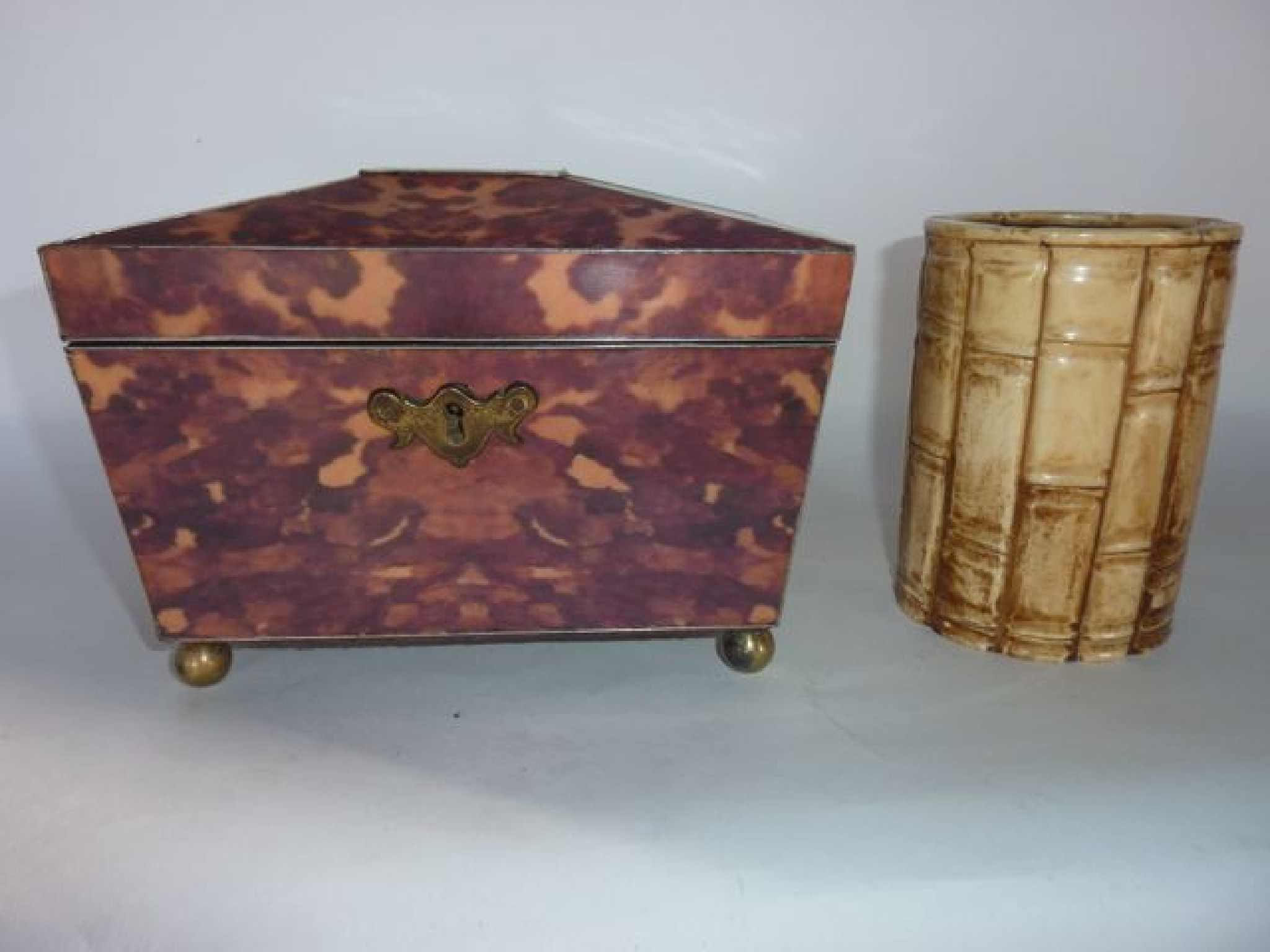 Appraisal: A sarcophagus shaped tea caddy constructed in faux tortoiseshell panels