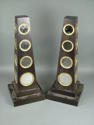 Appraisal: A pair of Empire style ebonised hardwood obelisks each fitted