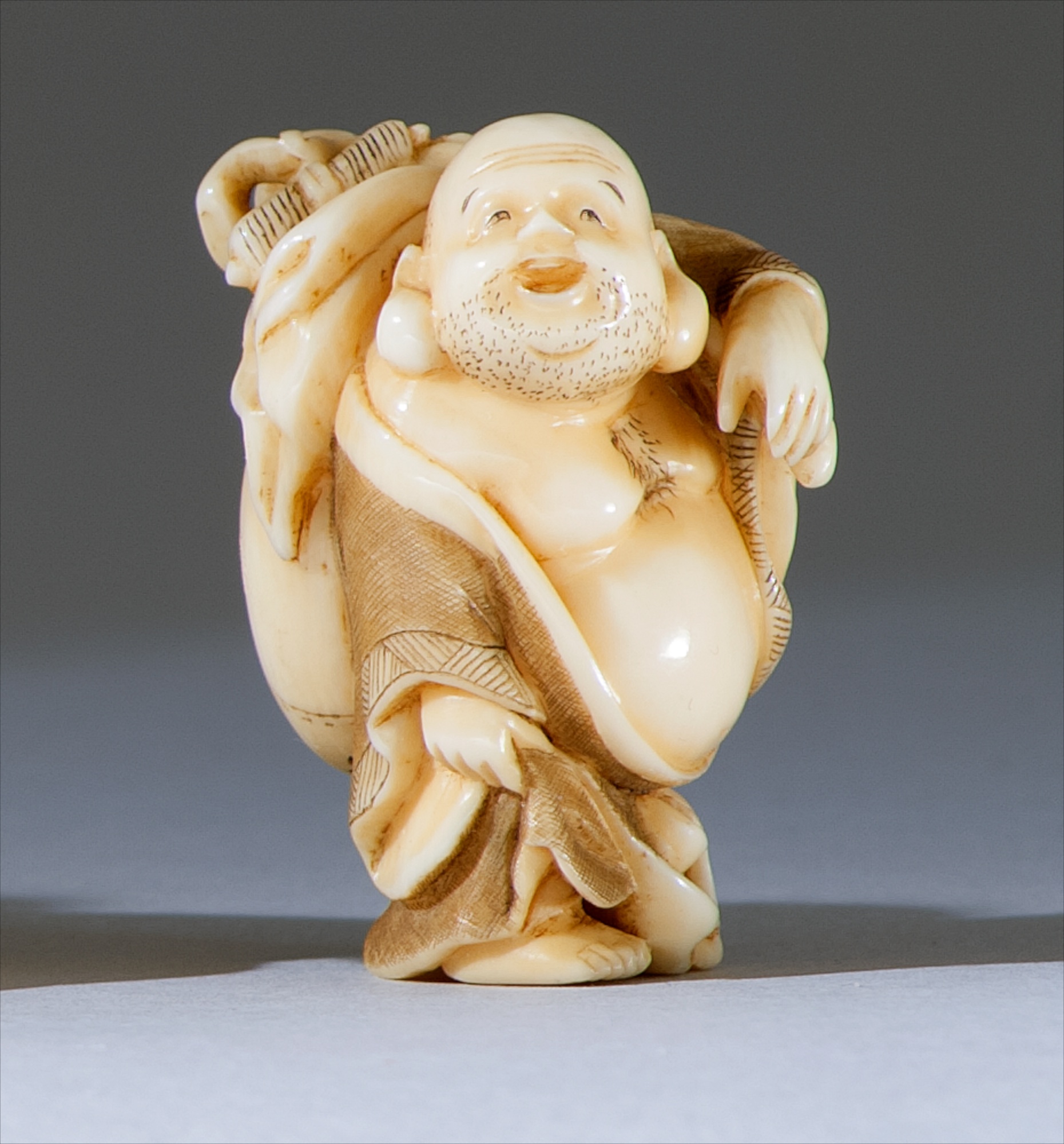 Appraisal: IVORY NETSUKE Meiji PeriodBy Yoshiyuki In the form of Hotei