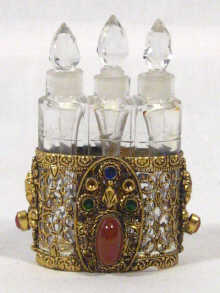 Appraisal: Three matching scent bottles in a gilt metal and gem