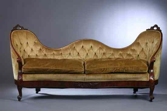 Appraisal: AMERICAN ROCOCO REVIVAL FLAME MAHOGANY TRIPLE-ARCH BACK SOFA probably New