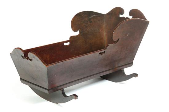 Appraisal: CRADLE Pennsylvania th century mahogany Dovetailed with elaborately scroll-cut top