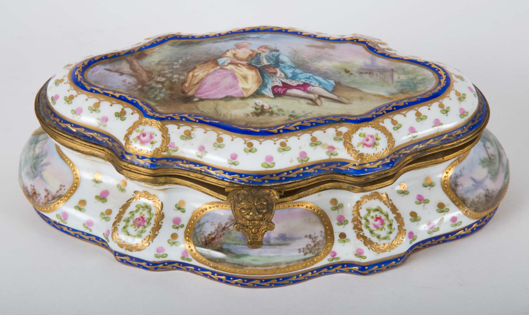 Appraisal: French gilt-metal-mounted porcelain jewelry box painted vignettes of lovers pseudo