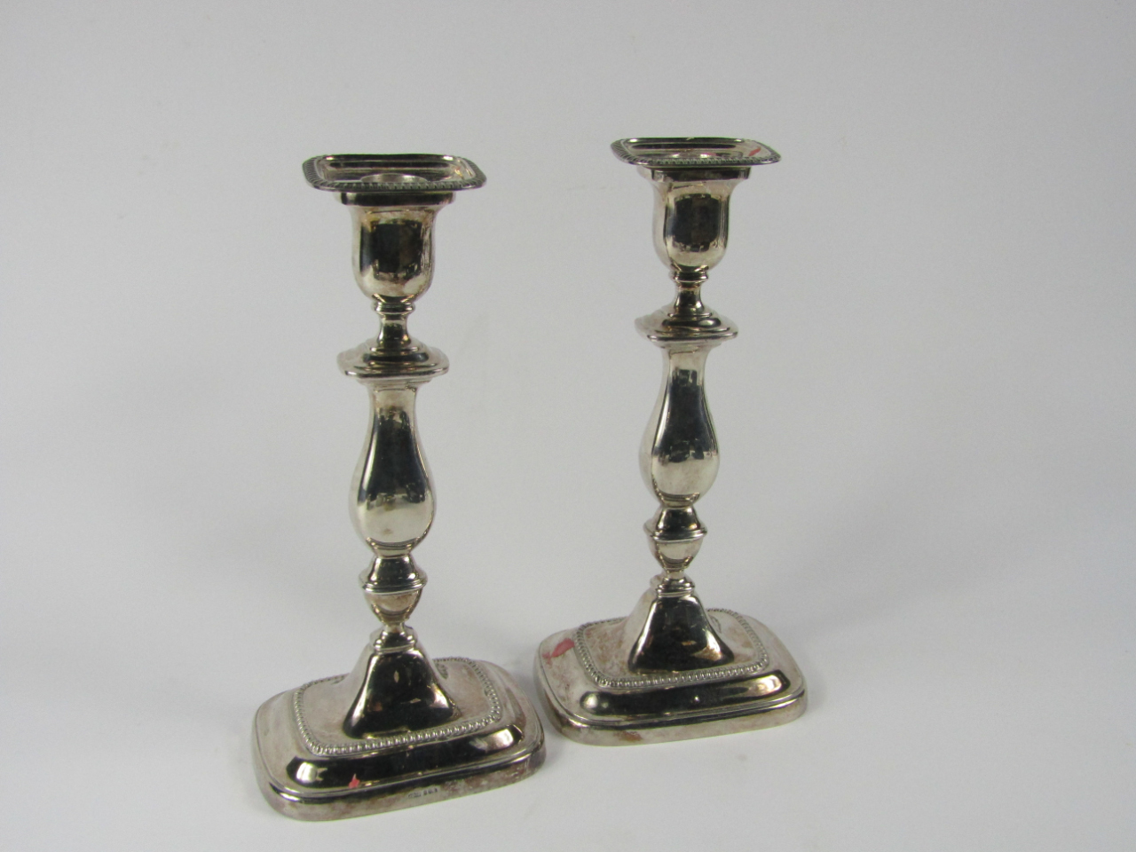 Appraisal: A pair of Elizabeth II silver candlesticks of Georgian baluster