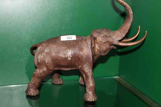 Appraisal: A CAST BRONZE MODEL of an elephant with trunk raised